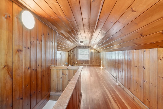 bonus room featuring hardwood / wood-style flooring, lofted ceiling, wooden ceiling, and wooden walls