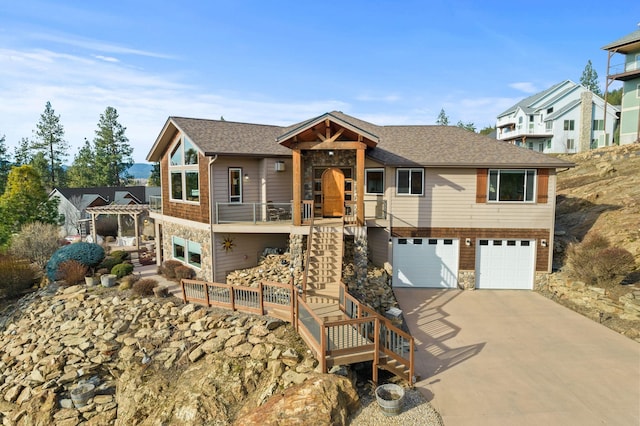 view of front facade featuring a garage, stone siding, concrete driveway, and stairs