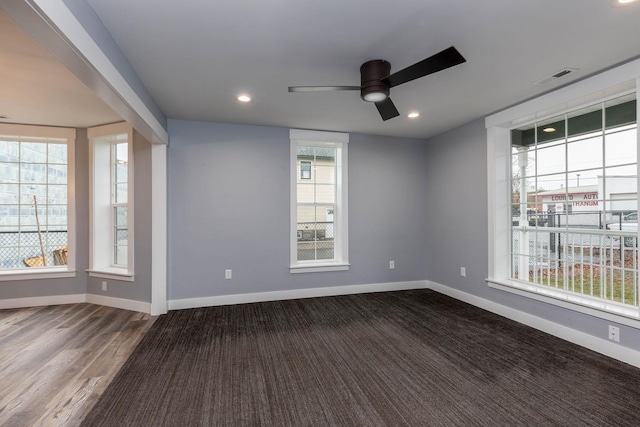 spare room featuring dark hardwood / wood-style flooring and ceiling fan