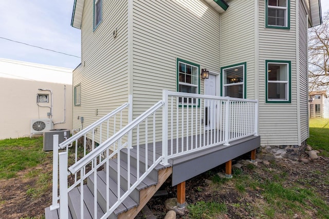 doorway to property with a deck, ac unit, and central air condition unit