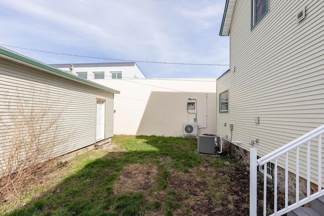 view of yard with central AC unit and ac unit