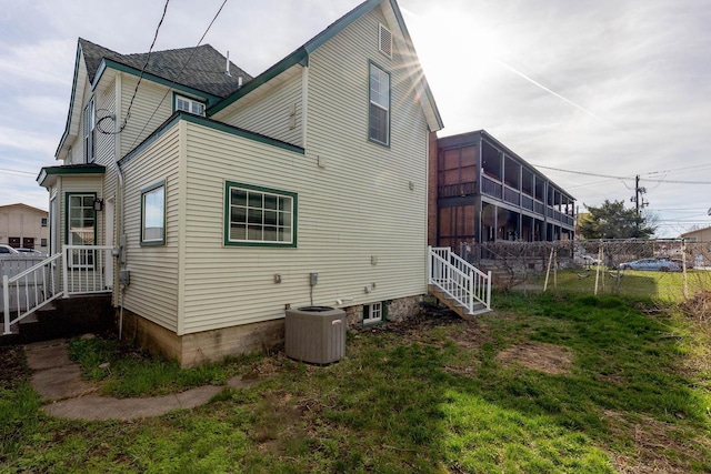 rear view of house with central AC unit