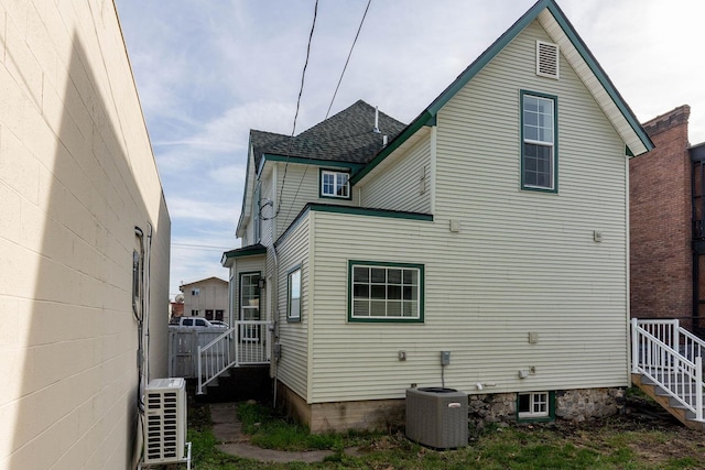 rear view of property featuring central AC unit and ac unit