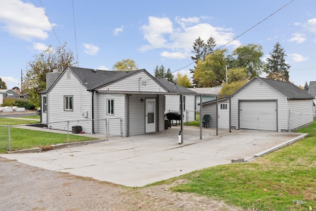 view of front facade with a garage, an outdoor structure, and a front yard