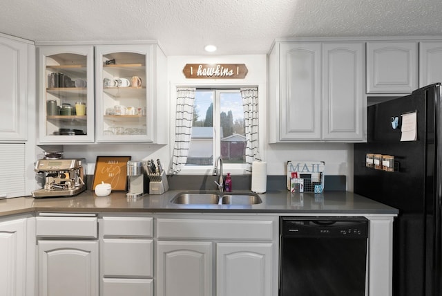 bar featuring white cabinetry, sink, a textured ceiling, and black appliances