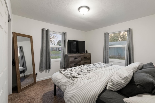 carpeted bedroom featuring a textured ceiling