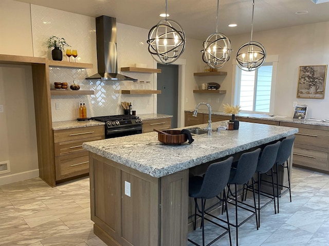 28411 N Milan Rd, Chattaroy, WA 99003 - kitchen with a kitchen bar, gas range, hanging light fixtures, an island with sink, and wall chimney range hood