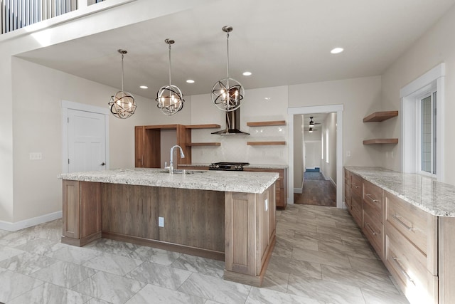28411 N Milan Rd, Chattaroy, WA 99003 - kitchen with hanging light fixtures, light stone countertops, sink, and a center island with sink