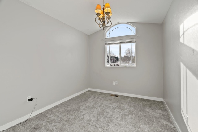 unfurnished room featuring an inviting chandelier, lofted ceiling, and carpet flooring