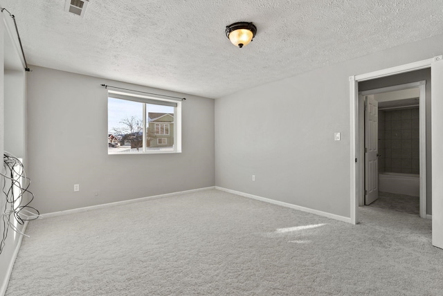 unfurnished bedroom featuring a textured ceiling and carpet flooring