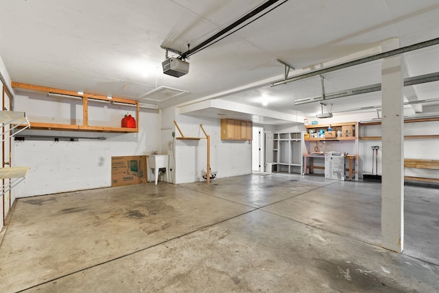 garage with a garage door opener and sink