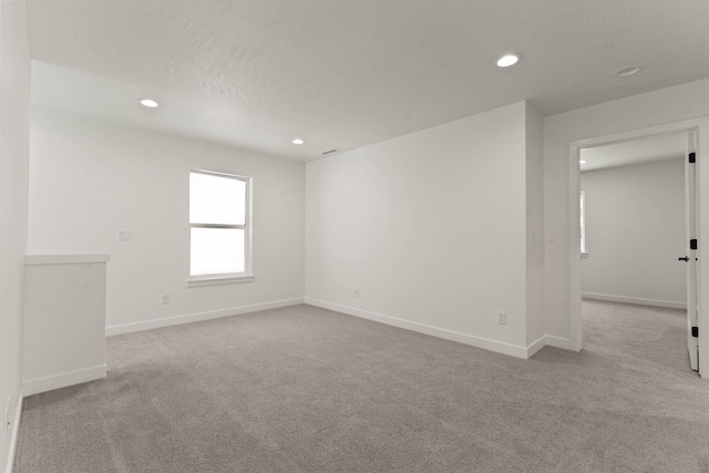 carpeted empty room with a textured ceiling