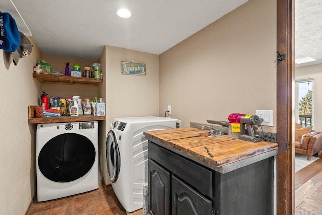 clothes washing area with washing machine and clothes dryer