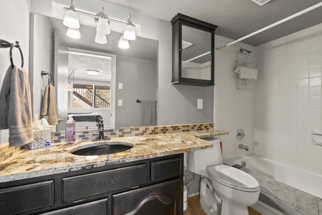 full bathroom with tasteful backsplash, vanity, toilet, and tiled shower / bath