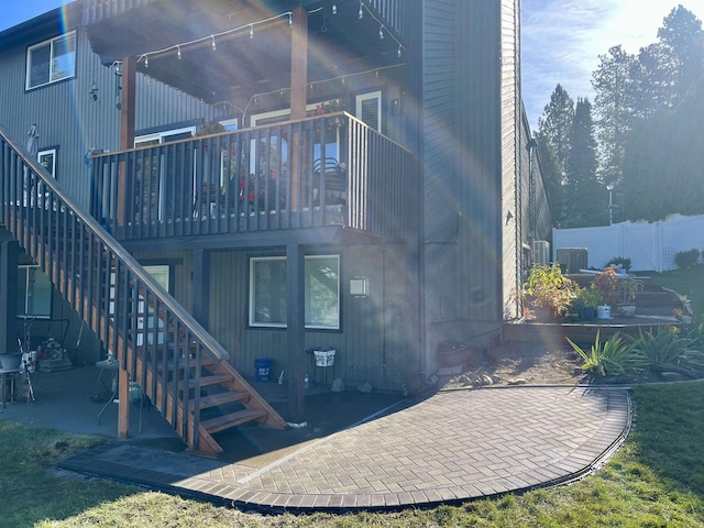 rear view of house with a balcony and a patio area