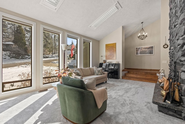 living room featuring lofted ceiling, a chandelier, carpet floors, and a textured ceiling