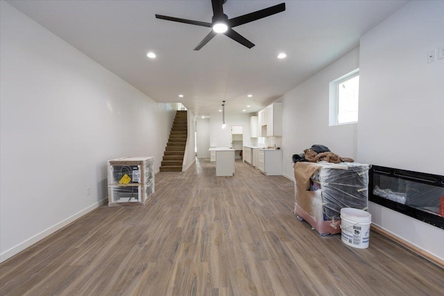 living room featuring hardwood / wood-style floors and ceiling fan