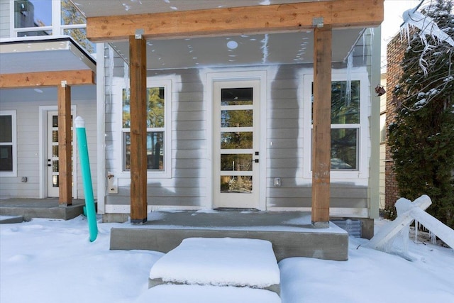 view of snow covered property entrance