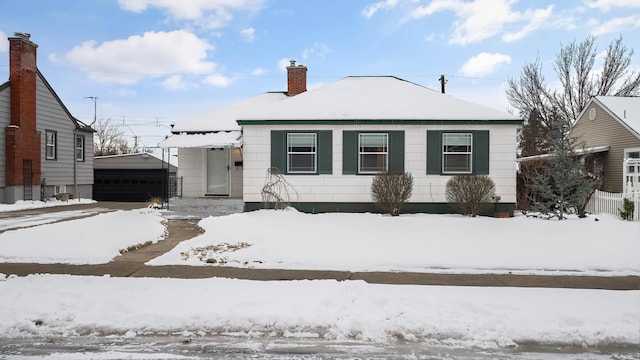 view of front of home with a garage and an outdoor structure