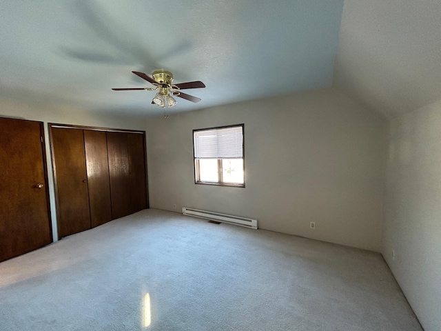 unfurnished bedroom with a baseboard heating unit, lofted ceiling, light colored carpet, and ceiling fan