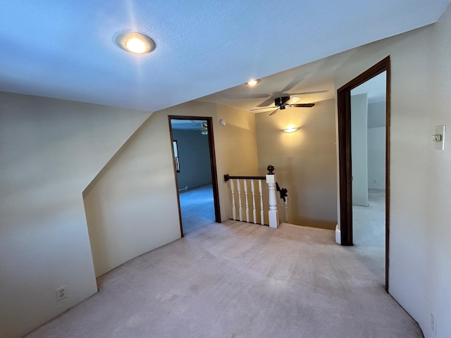 bonus room with carpet flooring and a ceiling fan