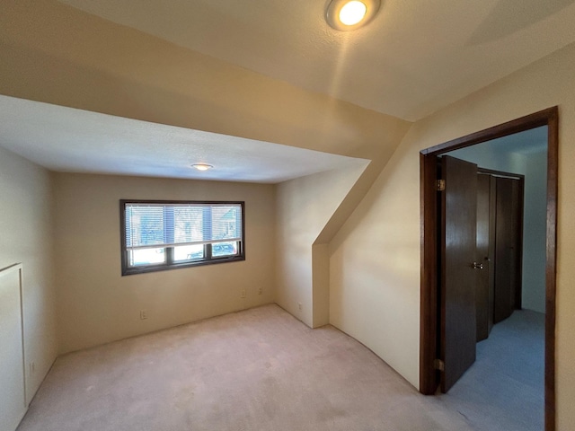 bonus room with light carpet