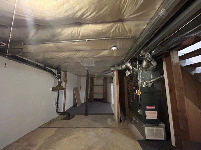 unfinished basement featuring heating unit