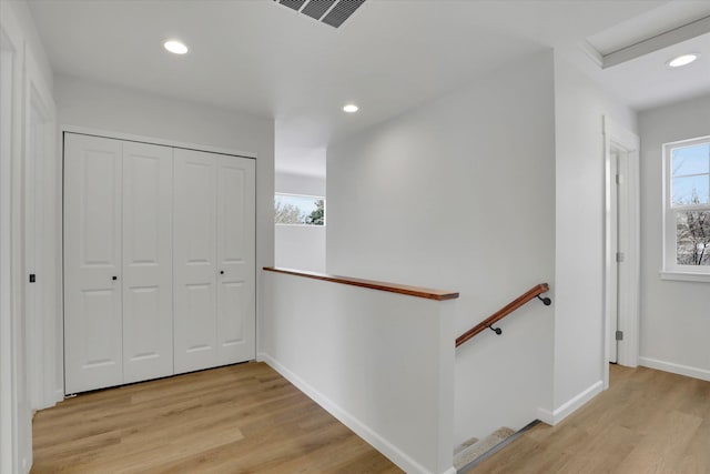 hallway with light hardwood / wood-style floors