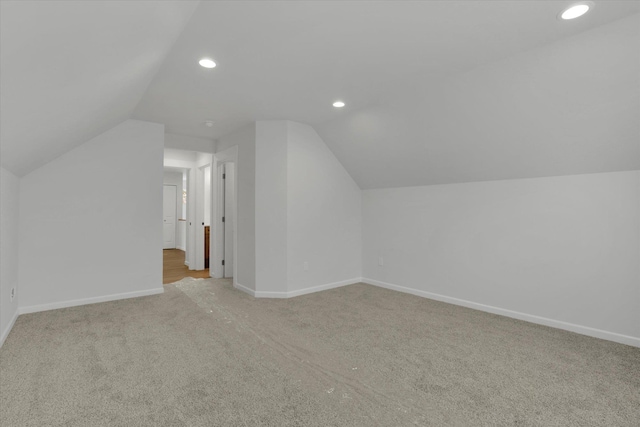 additional living space with lofted ceiling and light colored carpet