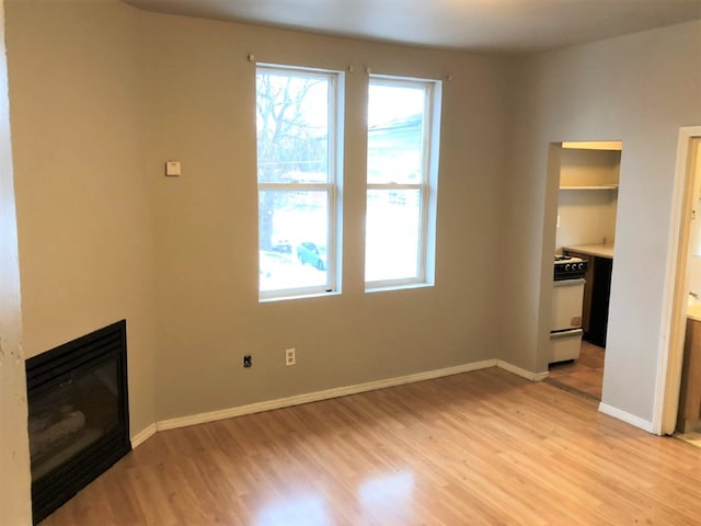 unfurnished living room with light wood-type flooring