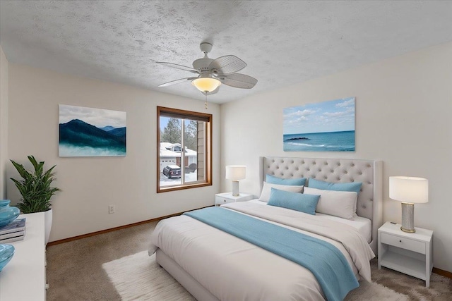 bedroom with ceiling fan, carpet floors, a textured ceiling, and baseboards