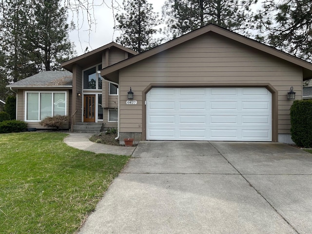 view of front of house featuring an attached garage, driveway, and a front lawn