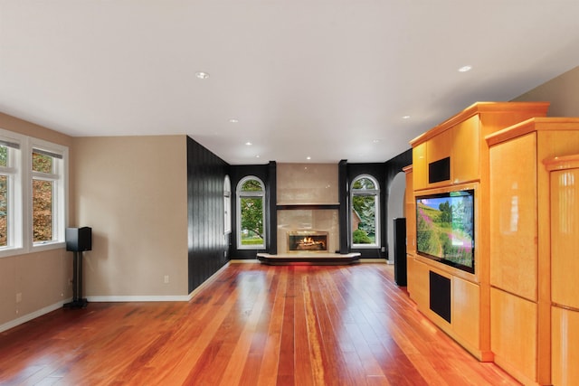 unfurnished living room with a fireplace and light hardwood / wood-style flooring