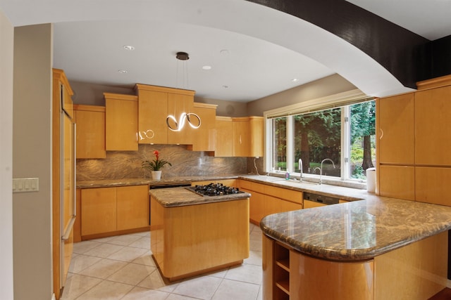 kitchen featuring stone counters, a center island, kitchen peninsula, and decorative backsplash