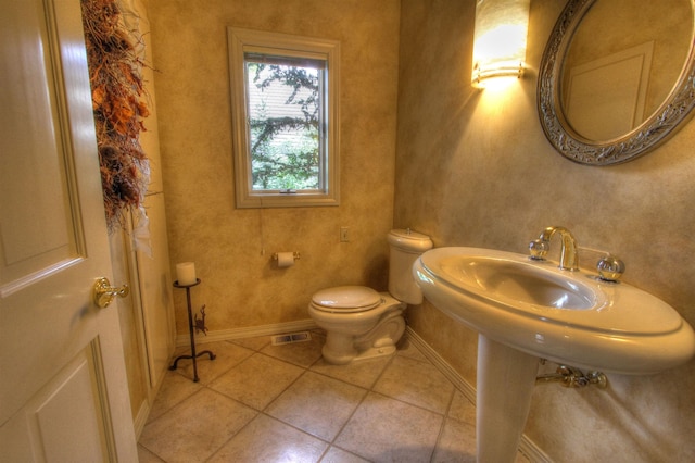 bathroom with tile patterned flooring and toilet