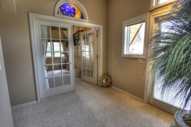 doorway to outside with french doors and carpet