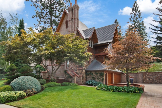 english style home with a front yard