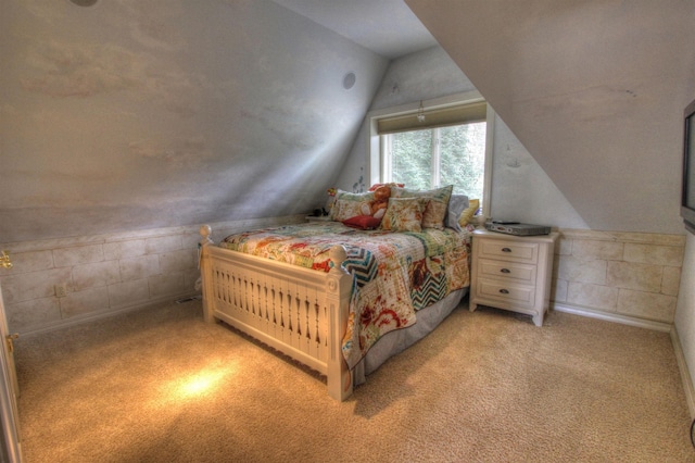 bedroom with lofted ceiling and light colored carpet