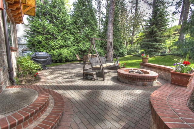 view of patio / terrace featuring grilling area, an outdoor fire pit, and a deck