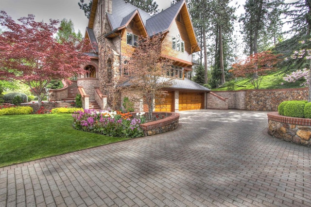 view of side of home featuring a garage and a yard