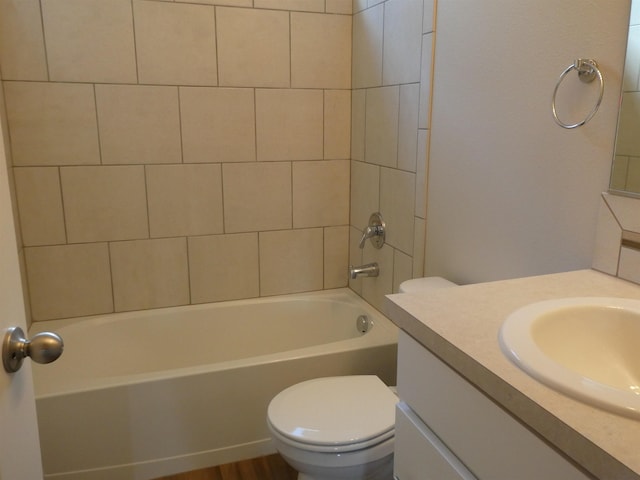 full bathroom with vanity, toilet, and tiled shower / bath combo