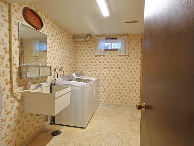 laundry area featuring sink and washer and clothes dryer