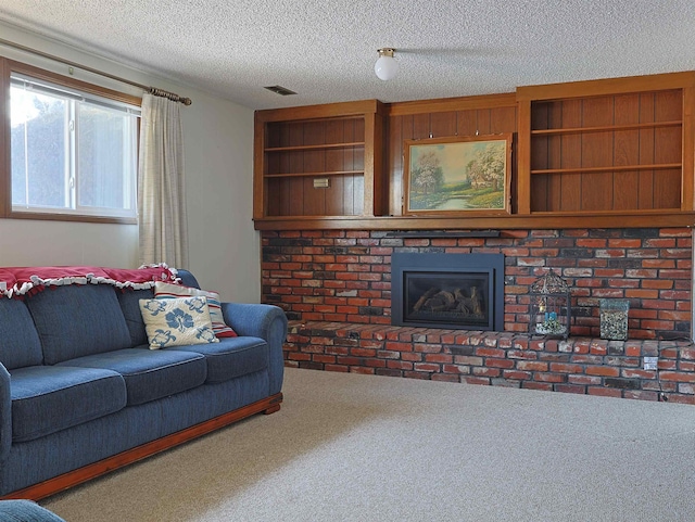 carpeted living room featuring a fireplace, built in features, and a textured ceiling