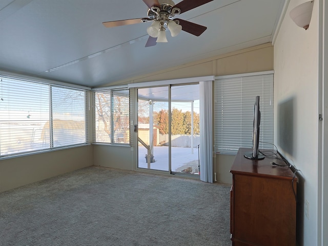 unfurnished sunroom featuring ceiling fan, vaulted ceiling, and a healthy amount of sunlight