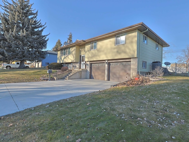 split foyer home featuring a garage and a front lawn