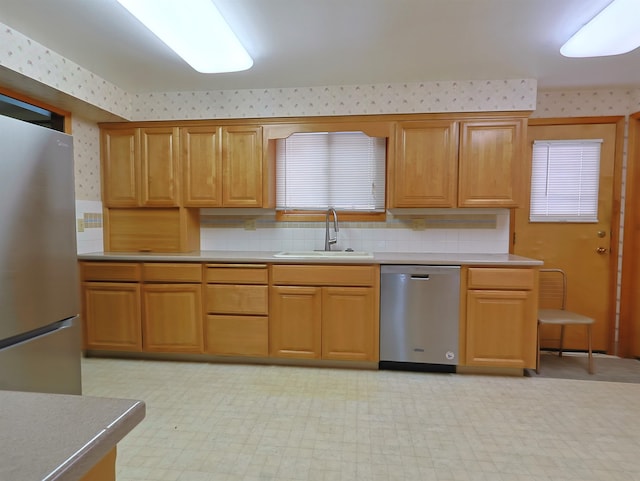 kitchen with sink, decorative backsplash, and stainless steel appliances