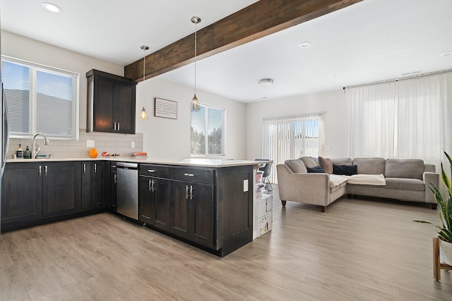 kitchen featuring tasteful backsplash, decorative light fixtures, light wood-type flooring, stainless steel dishwasher, and beam ceiling