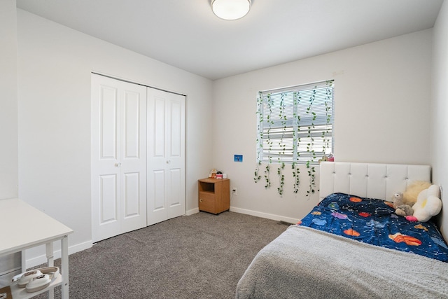 bedroom featuring a closet and dark colored carpet