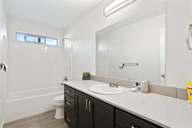 full bathroom with wood-type flooring,  shower combination, vanity, and toilet