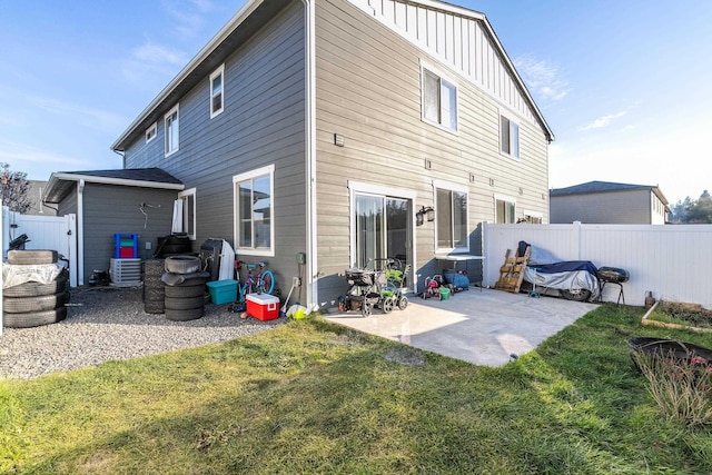 rear view of house with a yard and a patio area